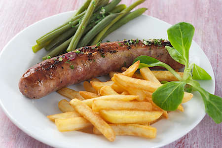grilled sausage and french fries and vegetableの写真素材