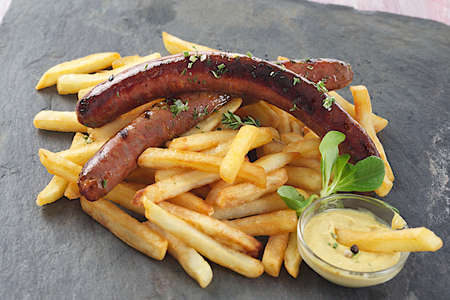grilled sausage and french fries with saladの写真素材