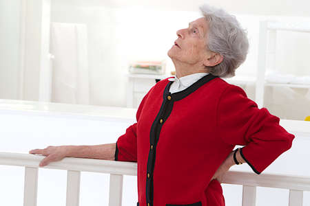 Old woman holding her lower back. Low back pain の写真素材