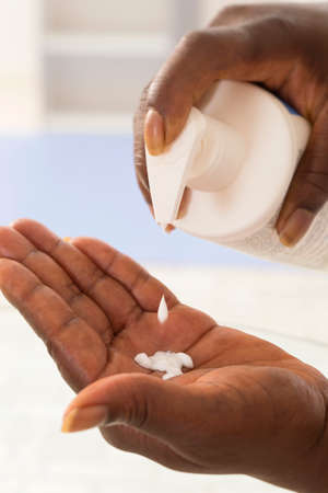 Pouring Moisturizer into Handの写真素材