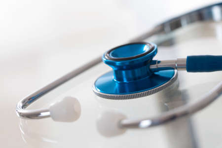Blue stethoscope isolated on whiteの写真素材