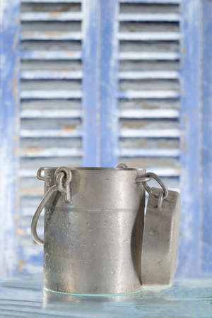 old jug of milk isolated on wooden backgrounfの写真素材