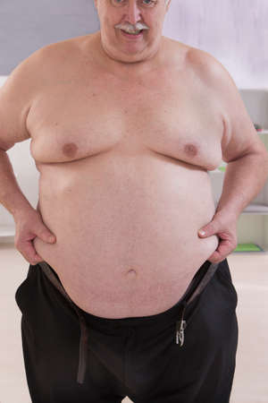 fat man touching his stomach