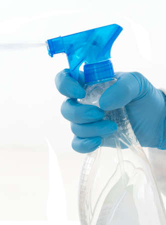 Hand with spray bottle isolated on a white