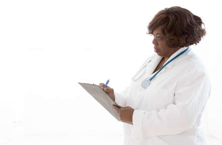 African doctor or nurse Writing in Chart on a white backgroundの写真素材
