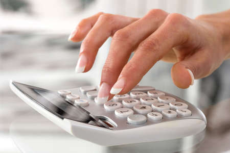 Hand with a calculatorの写真素材