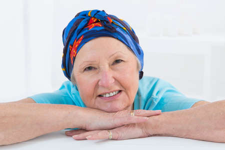 Portrait of a nice middle-aged woman recovering after chemotherapy - focus on her smiling relax attitudeの写真素材