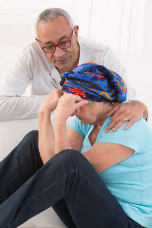 Cancer patient supported by her loving husband. White backgroundの写真素材