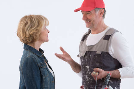 Senior woman with smiling painter man isolated on white backgroundの写真素材