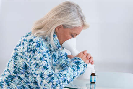 Senior woman making inhalationの写真素材