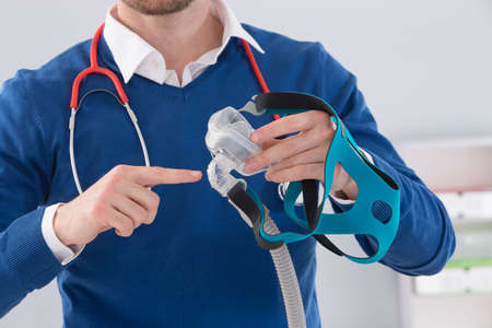 Doctor explaining the CPAP machine and mask Concept  for sleep apnea