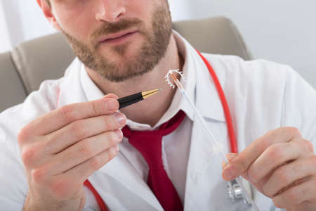 Gynecology Consultation-Doctor explaining IUD concept-Birth control copper coil deviceの写真素材