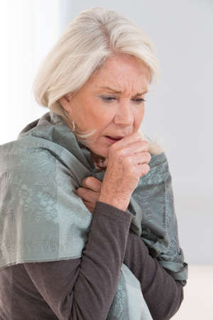 Sick woman coughing with sore throatの写真素材