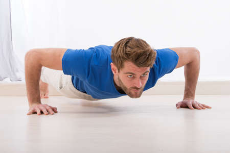 Sexy Young fashion sport man, fitness muscle model guy making push ups exercise
