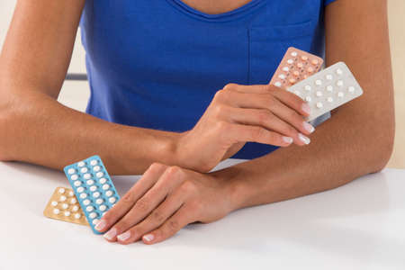 Young woman with Contraceptive Pillの写真素材