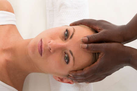 Reflexology: Portrait Of Young Beautiful Woman Receiving Head Massage At Spaの写真素材