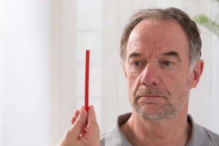 Senior man being hypnotized by hypnotherapistの写真素材