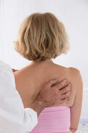 Chiropractor massage the female patient spine and backの写真素材