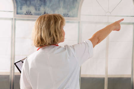 Back view of male medical doctor pointing at somethingの写真素材