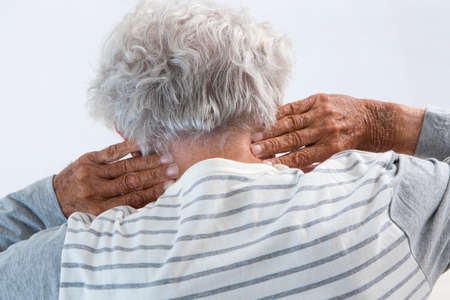 Senior man suffering from neck acheの写真素材