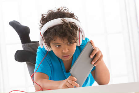close up of teenage boy in headphones  listening to music or playing onlineの写真素材