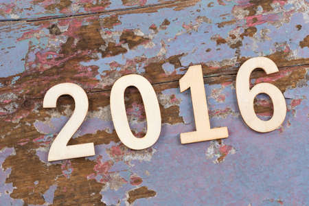 Sigh symbol from number 2016 on old retro vintage style wooden texture background
