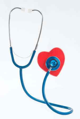 Medical stethoscope and heart isolated on white