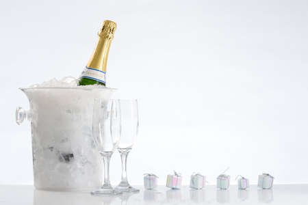 Bottle of champagne in bucket isolated on whiteの写真素材