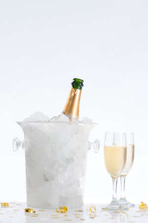 Bottle of champagne in bucket isolated on whiteの写真素材