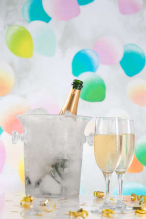 Glasses and Bottle of champagne. background of lightsの写真素材