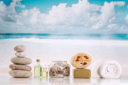 spa accessories with stones on beach background