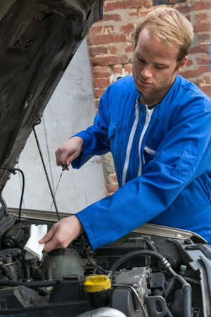 Car mechanic check oil levelの写真素材