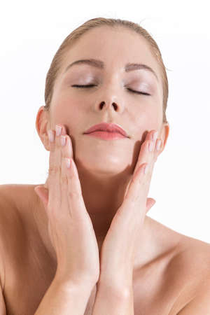 Beautiful  woman touching her face closed eyesの写真素材