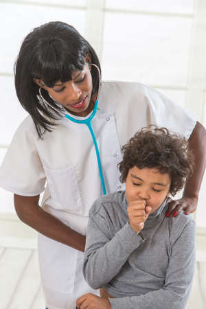 female doctor examining little young  boyの写真素材