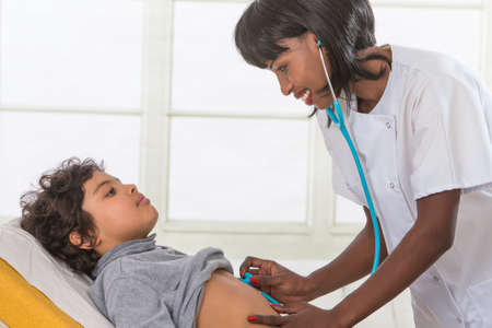 female doctor examining little young  boyの写真素材