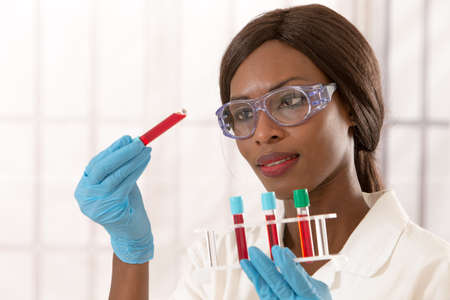 african lab assistant  with rack of blood testの写真素材