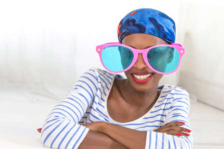 African woman wearing funny oversized glasses
