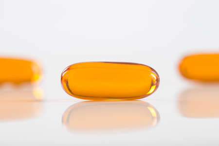 gels pills with Omega-3 oil on whiteの写真素材