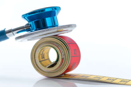 Stethoscope with   measurement tape on white backgroundの写真素材
