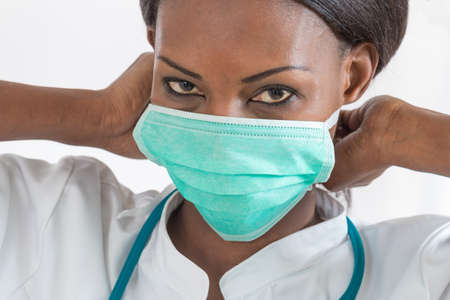Smiling African American nurse at hospital  with maskの写真素材