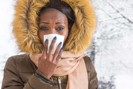 sick african  woman   blowing nose with tissue,  Flu season, vaccine