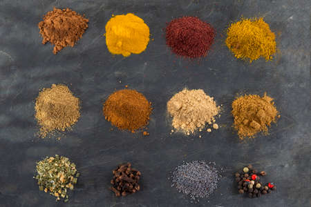 Selection of various bay and spice powder on slate backgroundの写真素材