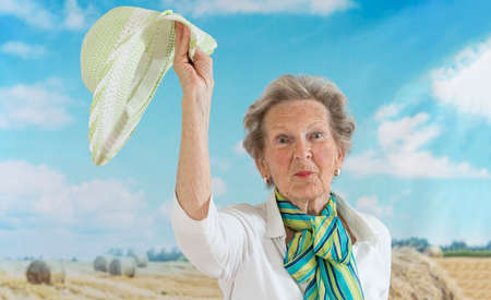 beautiful smiling senior woman enjoying life in countrysideの写真素材