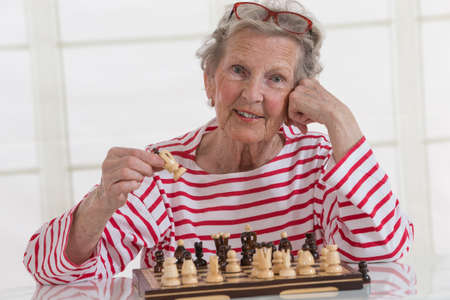 Senior Woman training to play Chess alone