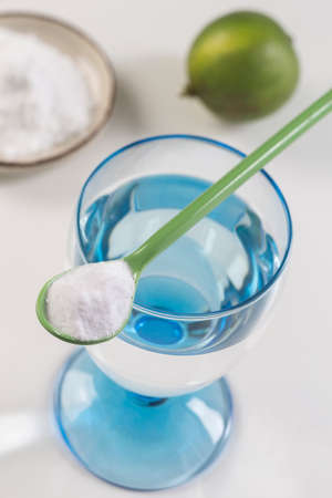 A glass of water, lemon, soda bicarbonateの写真素材