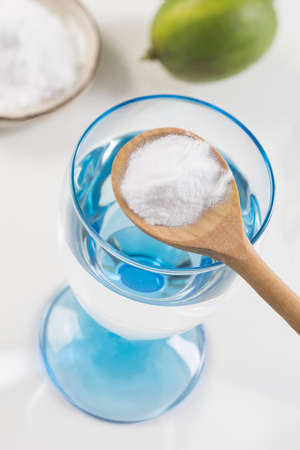 A glass of water, lemon, soda bicarbonateの写真素材