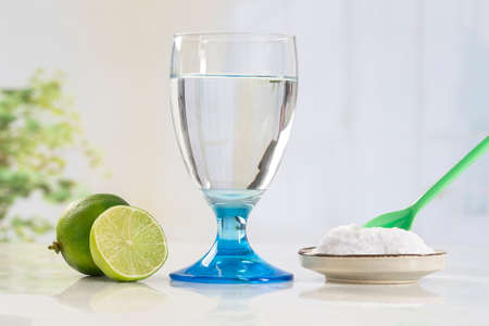 A glass of water, lemon, soda bicarbonateの写真素材