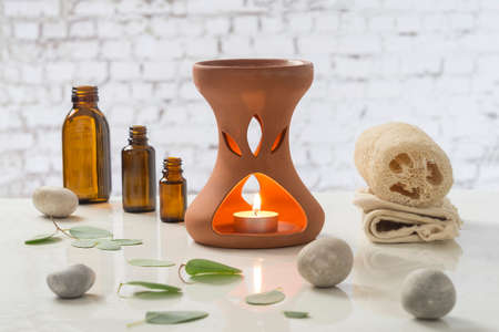 Aromatherapy candles burning and bath towels for a relaxationの写真素材