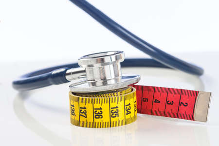 Tape measure with stethoscope on white backgroundの写真素材