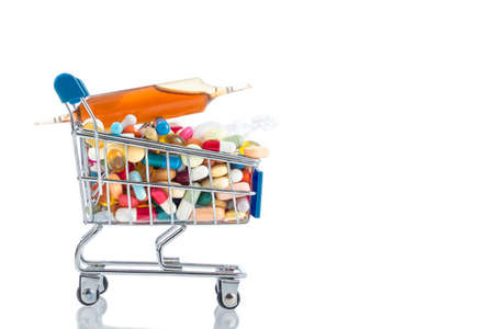 Isolated shopping cart full of vitamin supplements on white backgroundsの写真素材